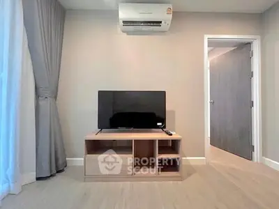 Modern living room with TV and air conditioning in a stylish apartment.