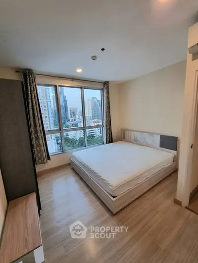 Spacious bedroom with city view in modern apartment