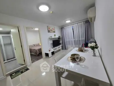 Modern open-plan living and dining area with elegant decor and natural light.