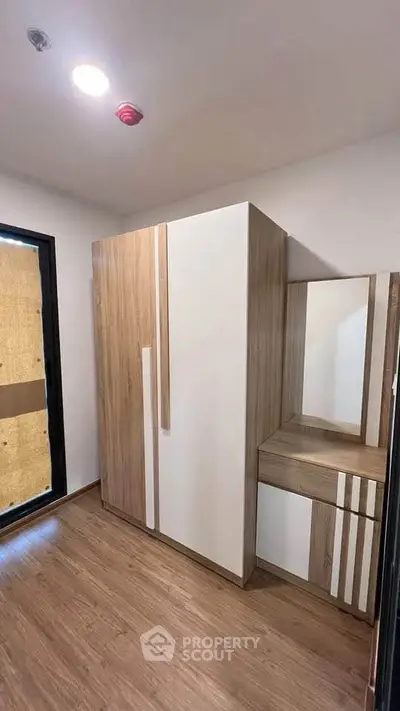 Modern bedroom with sleek wooden wardrobe and vanity set
