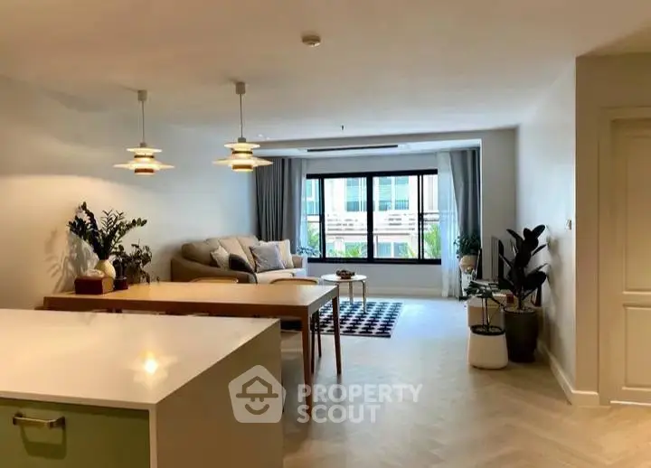 Spacious modern living room with stylish decor and large windows offering natural light.