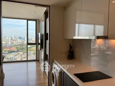 Spacious modern living room with panoramic city view and large windows.