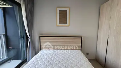 Modern bedroom with minimalist decor and large window for natural light