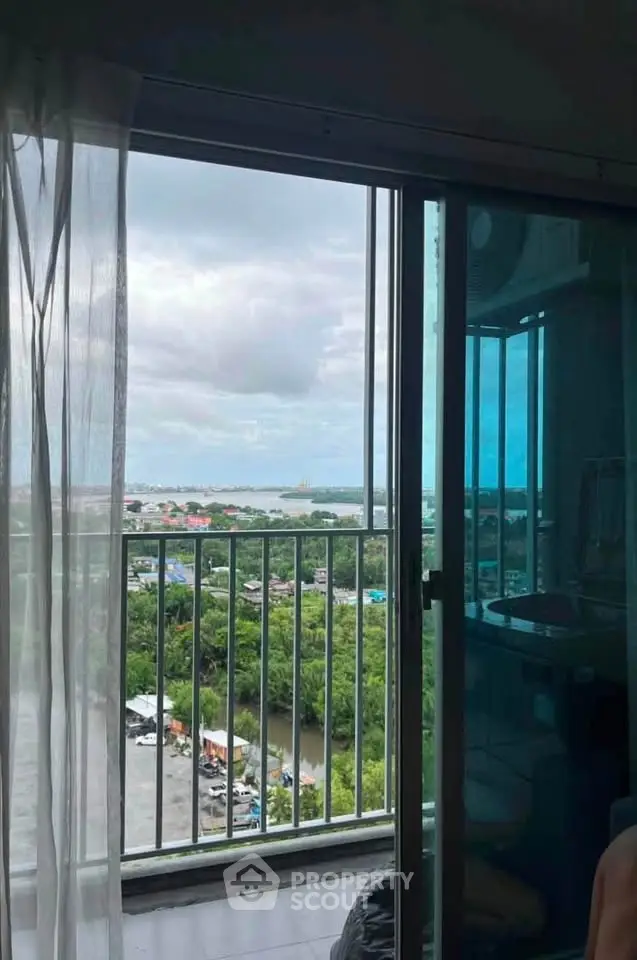 Stunning high-rise apartment view with expansive balcony overlooking lush greenery and cityscape.