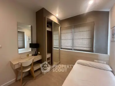 Cozy bedroom with modern decor and ample natural light