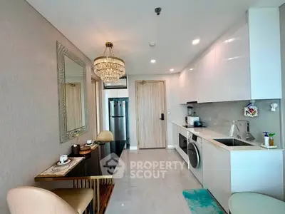 Modern kitchen with sleek white cabinets, integrated appliances, and elegant dining area.
