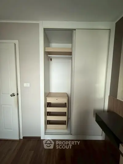 Modern bedroom with built-in wardrobe and sleek wooden flooring