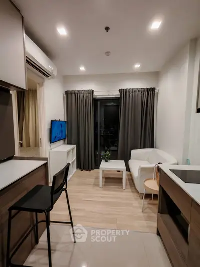 Modern living room with sleek furniture and open kitchen layout