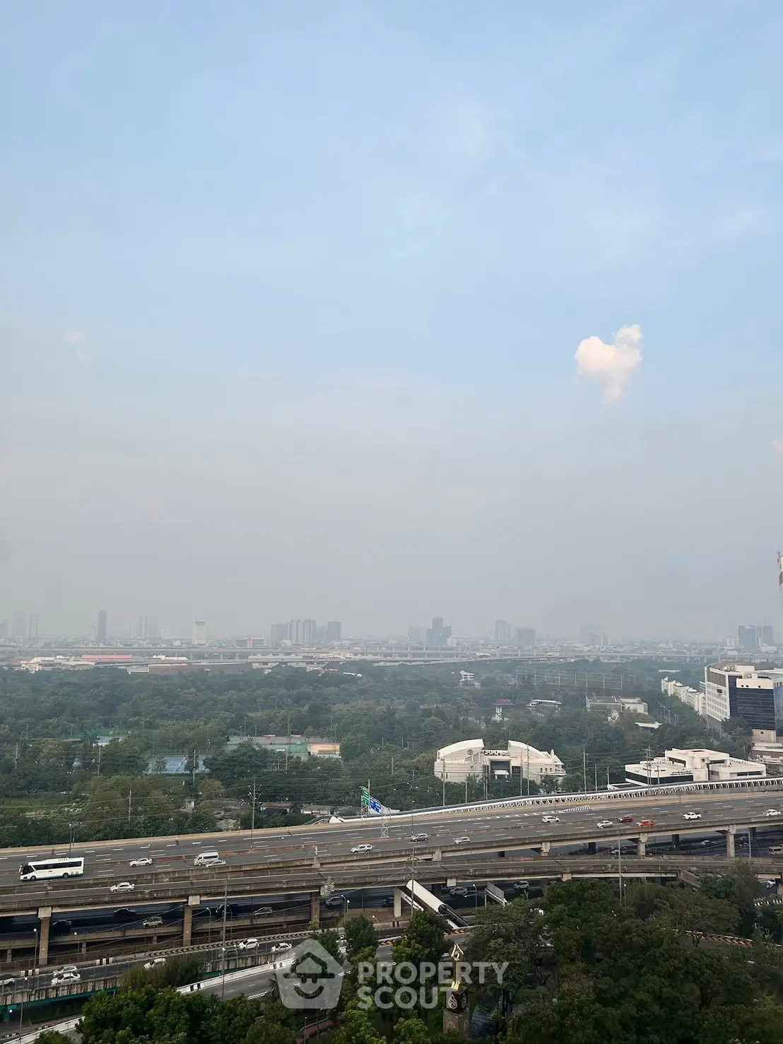 Stunning cityscape view from high-rise building overlooking highway and skyline.
