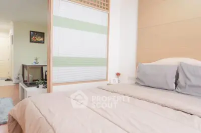 Cozy bedroom with neutral tones and modern decor, perfect for relaxation.