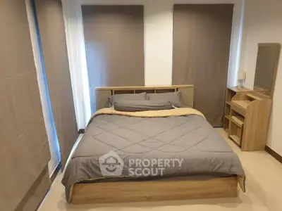 Modern bedroom with stylish wooden furniture and cozy bedding, perfect for relaxation and comfort.