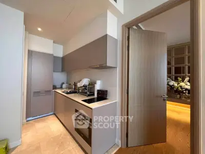 Modern kitchen with sleek cabinetry and built-in appliances in a stylish apartment.