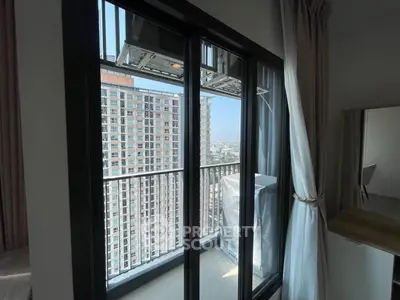 Modern apartment balcony with city view and sliding glass doors