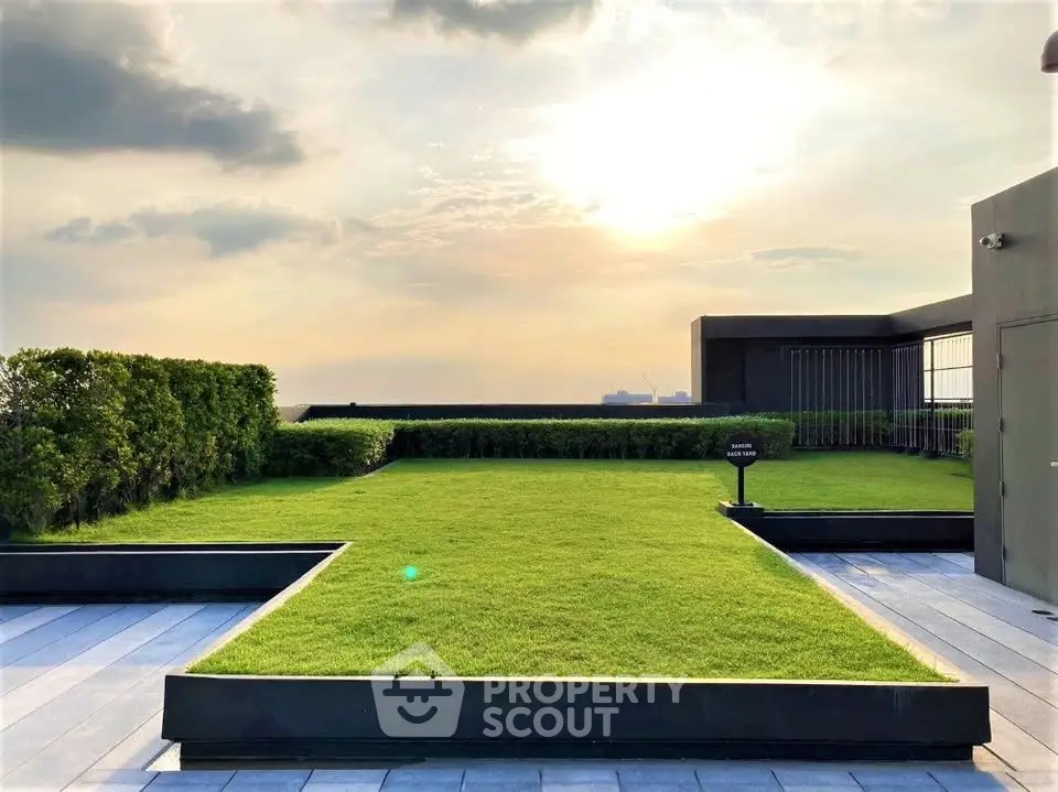 Stunning rooftop garden with lush greenery and panoramic sunset views.