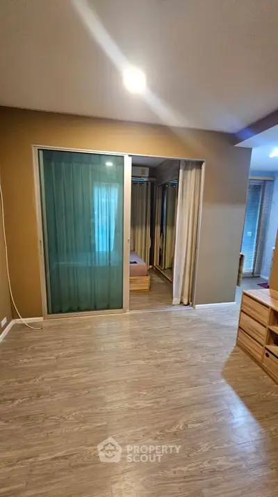 Spacious modern living room with wooden flooring and sliding glass doors