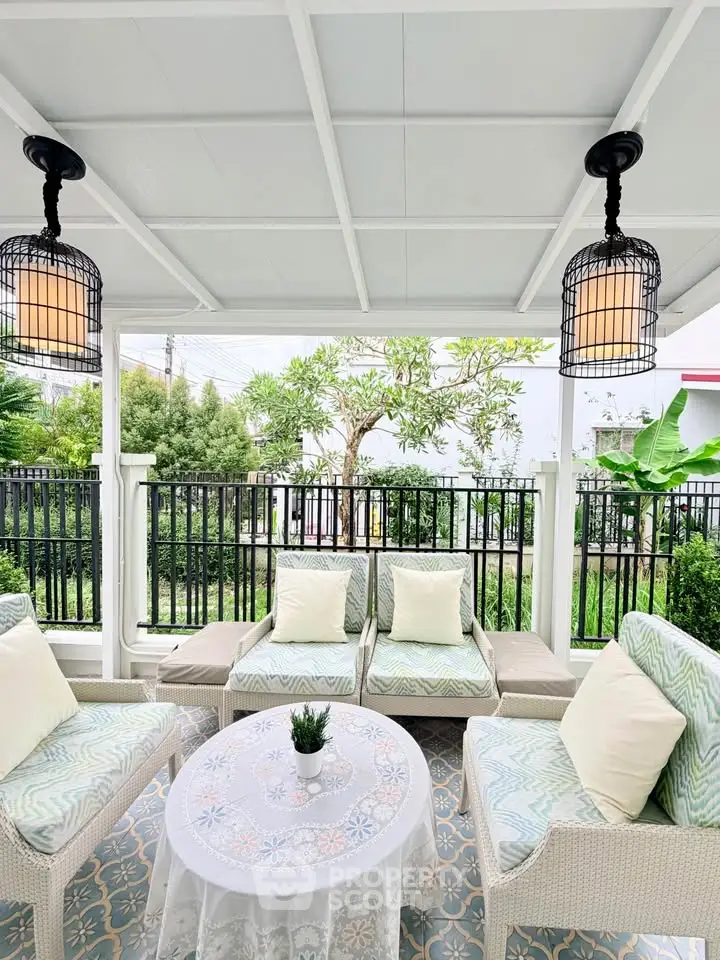 Charming outdoor patio with cozy seating and lush garden view, perfect for relaxation and entertaining.