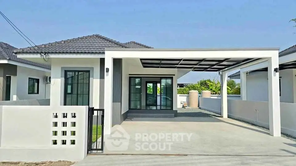 Modern single-story house with spacious carport and sleek design in a serene neighborhood.