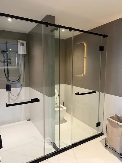 Modern bathroom with glass shower enclosure and sleek design.