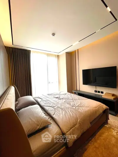 Luxurious bedroom with modern decor and large window offering natural light.