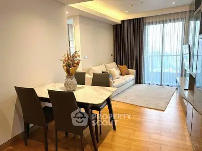 Modern living room with elegant dining area and cozy sofa, featuring floor-to-ceiling windows and wooden flooring.