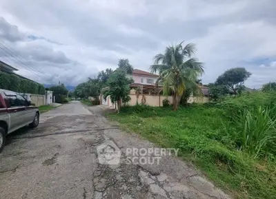 Charming suburban house with lush greenery and palm trees, perfect for tranquil living.
