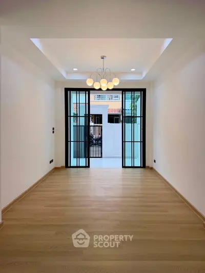 Spacious modern living room with elegant lighting and large windows