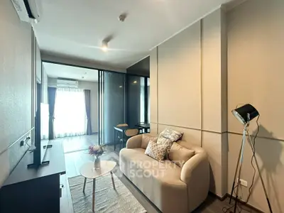 Modern living room with cozy sofa and stylish decor in a contemporary apartment.