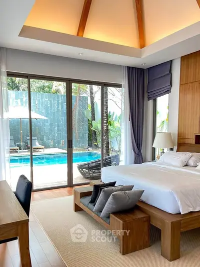 Luxurious bedroom with pool view, featuring modern wooden furniture and elegant decor.