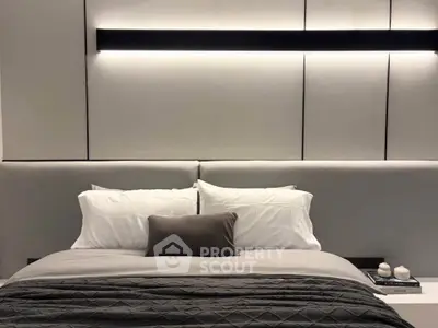 Luxurious modern bedroom with elegant lighting and plush bedding