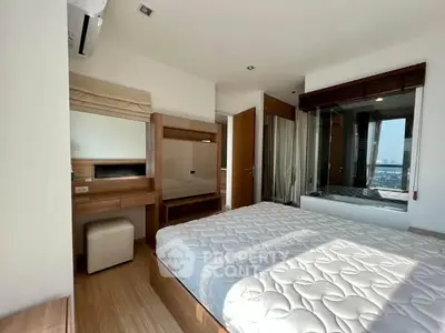 Bright and airy bedroom with modern furnishings and large window view.