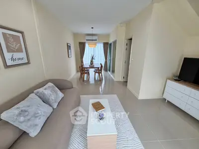Spacious living room with modern decor and dining area, perfect for family gatherings.
