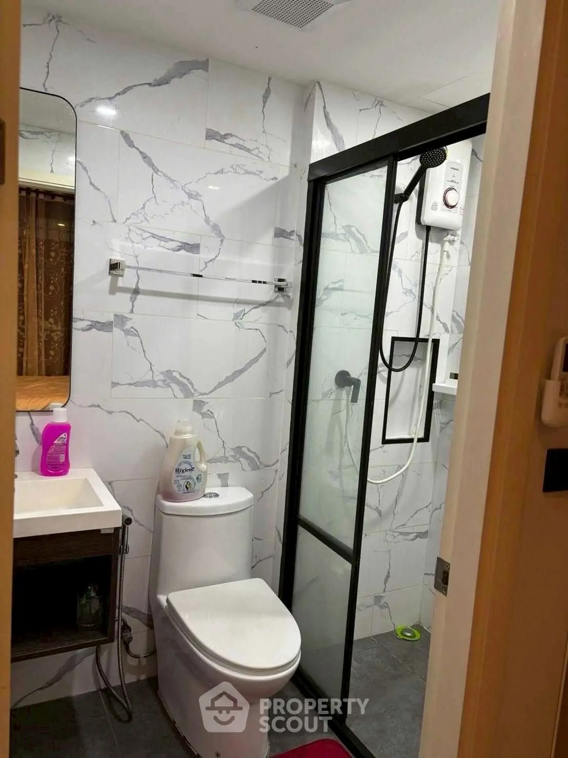 Modern bathroom with marble tiles and glass shower enclosure