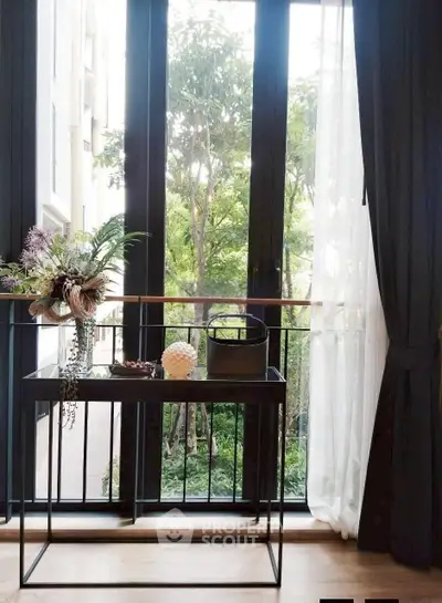 Charming window view with elegant decor and lush greenery outside, perfect for a serene living space.