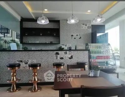 Stylish modern kitchen with bar stools and decorative lighting