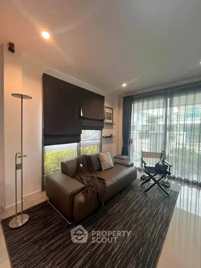 Stylish living room with modern decor and large windows for natural light