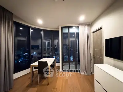 Modern dining area with floor-to-ceiling windows and city view
