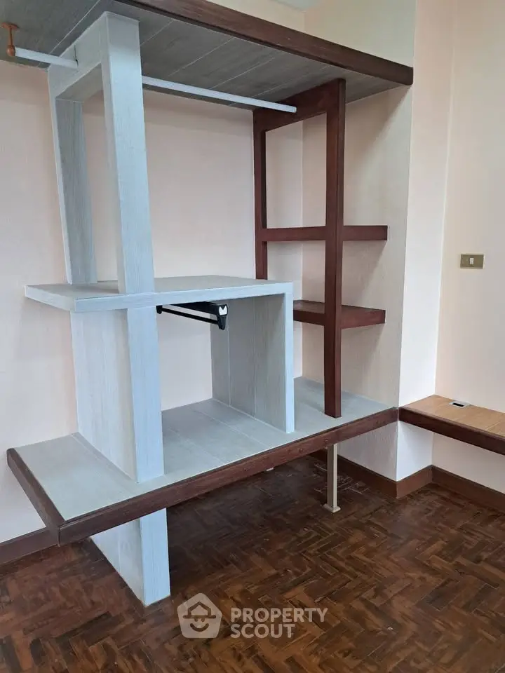 Modern interior shelving unit with wooden flooring in stylish room