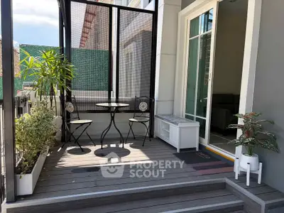 Charming balcony with stylish outdoor seating and lush greenery, perfect for relaxation and entertaining.