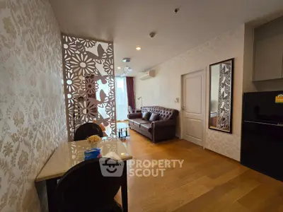 Stylish living room with elegant decor and modern furniture, featuring a decorative partition and wooden flooring.