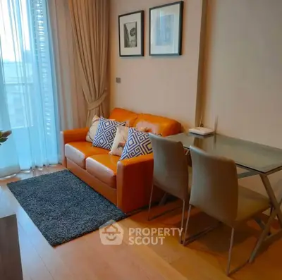 Chic living room with orange sofa and glass dining table, perfect for modern urban living.
