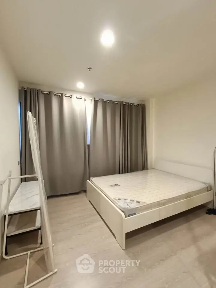 Spacious bedroom with modern minimalist design and ample natural light