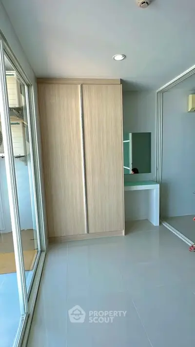 Modern bedroom with sleek wardrobe and mirrored sliding doors