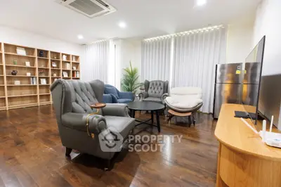 Spacious living room with elegant furniture and wooden flooring