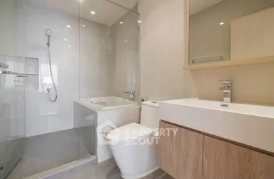 Modern bathroom with glass shower and sleek fixtures