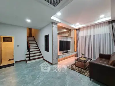 Spacious modern living room with elegant decor and staircase