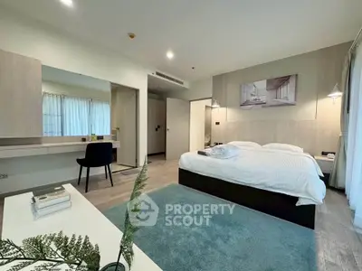 Spacious modern bedroom with elegant decor and natural light