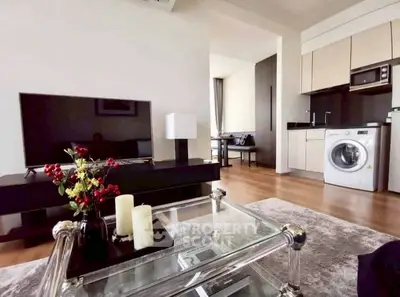 Modern living room with sleek furniture and integrated kitchen appliances.