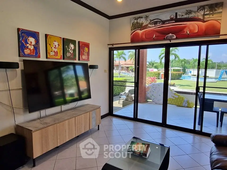 Stylish living room with modern decor and pool view, perfect for relaxation and entertainment.