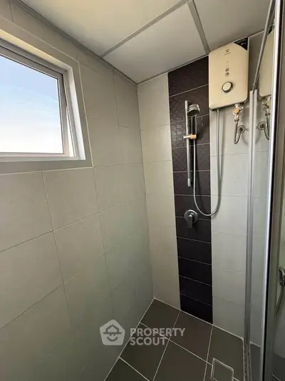 Modern bathroom with sleek shower and window for natural light