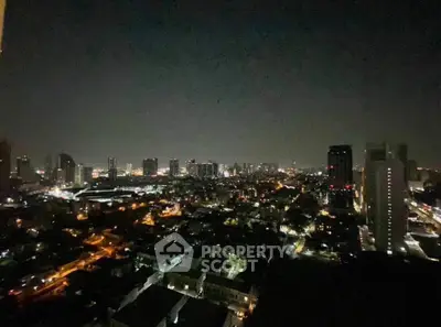 Stunning cityscape night view from a high-rise building, showcasing vibrant urban lights.